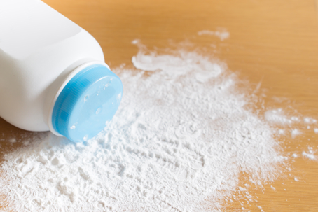 talcum powder container on wooden background